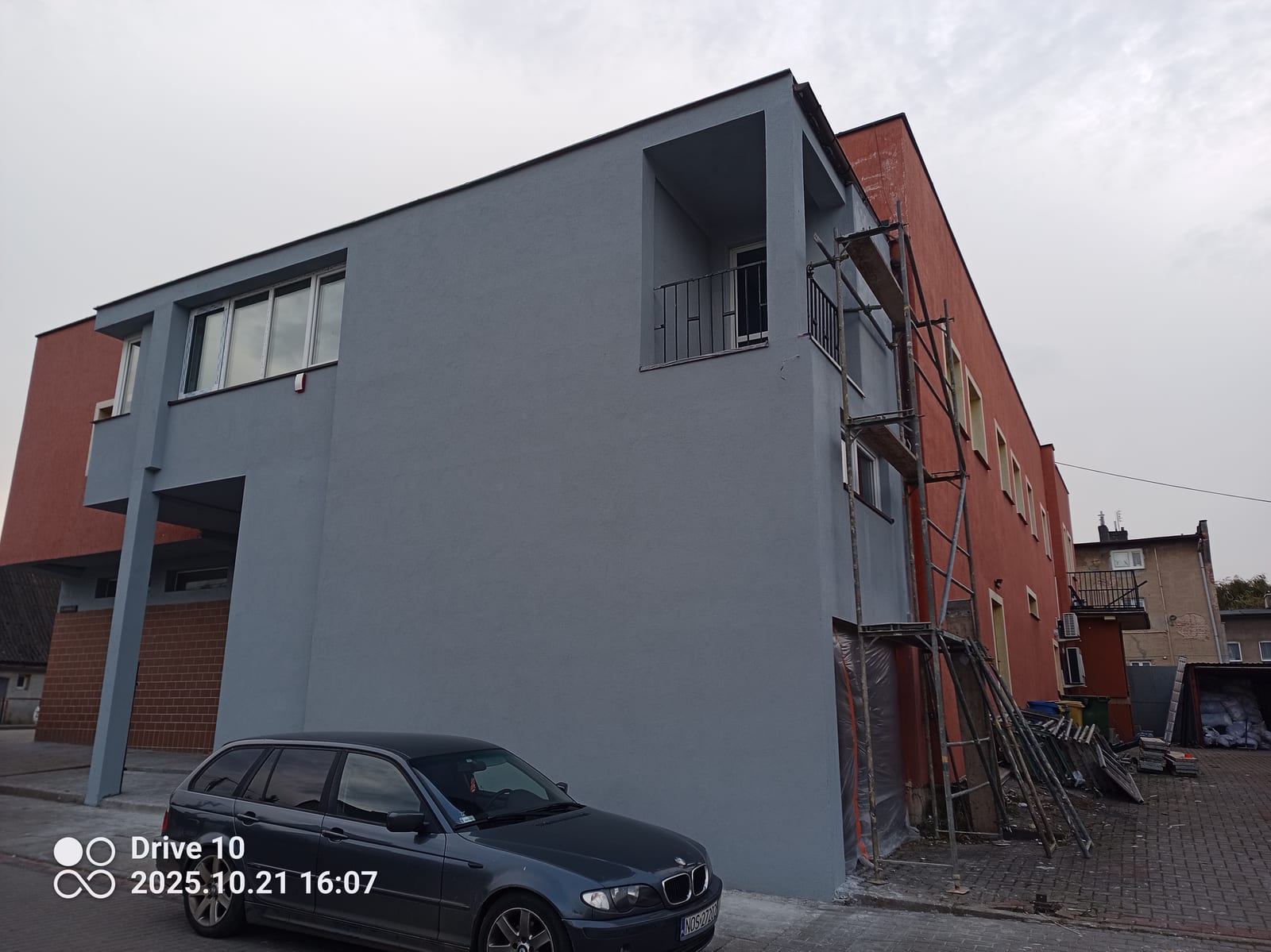 Facade insulation and render on a commercial building, After